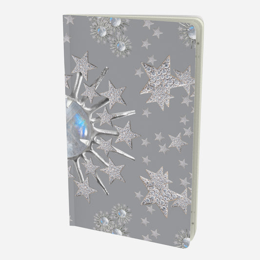 front cover of small notebook with celestial moonstone and stars design on a grey background