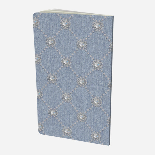 back cover of small notebook with celestial moonstone and stars lattice design on a chambray denim look background