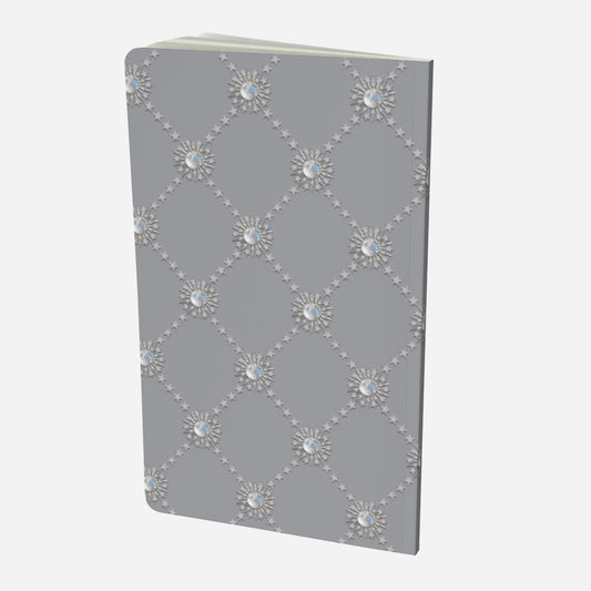 back cover of small notebook with celestial moonstone and stars lattice design on a grey background