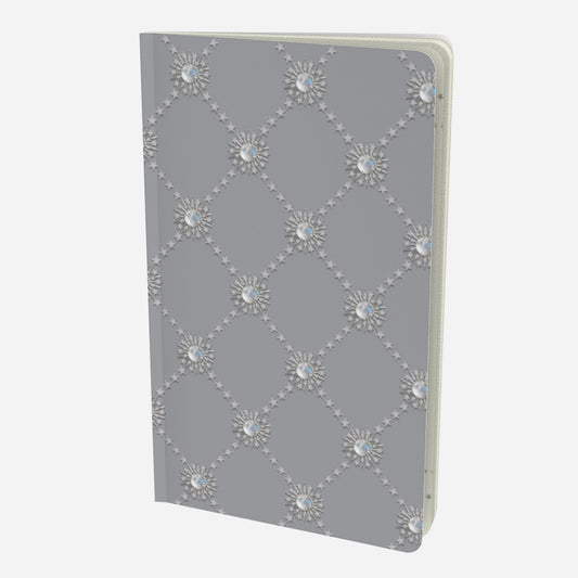 front cover of small notebook with celestial moonstone and stars lattice design on a grey background