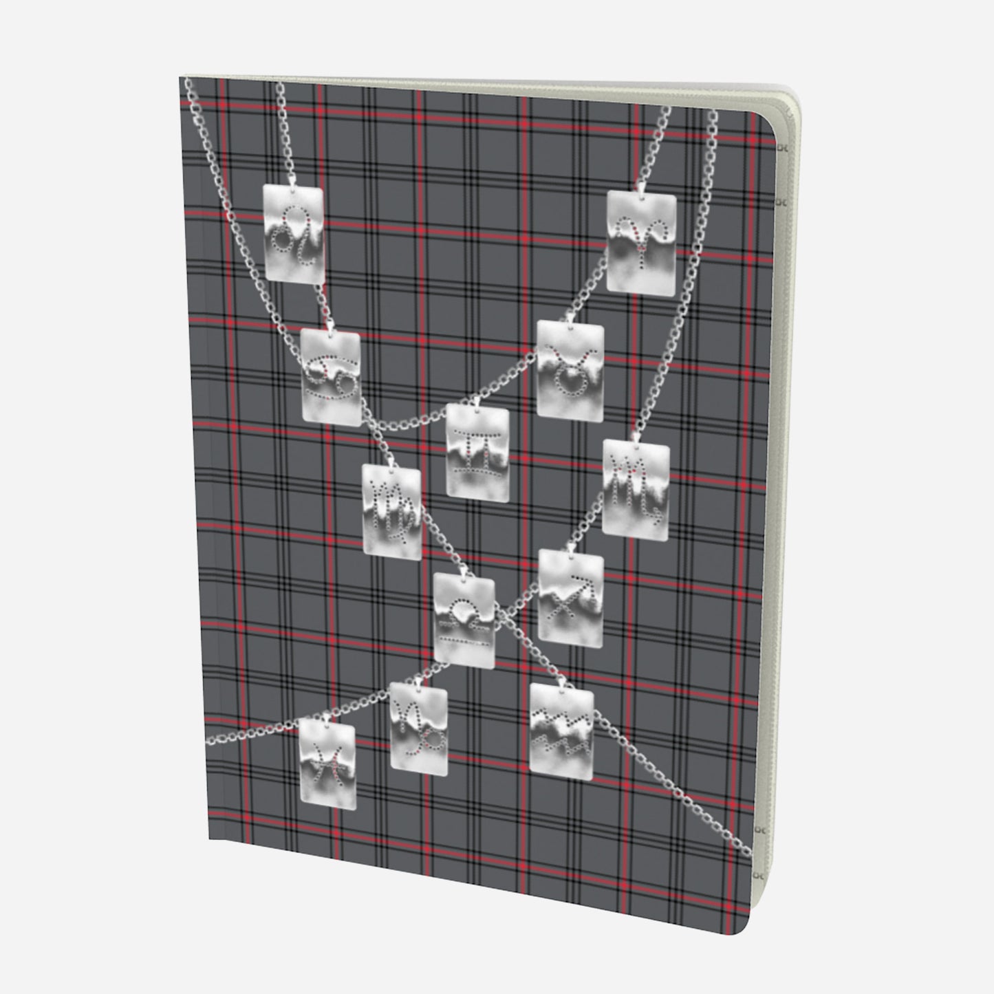 front cover of large notebook with silver zodiac tags on chains on a grey red and black plaid background