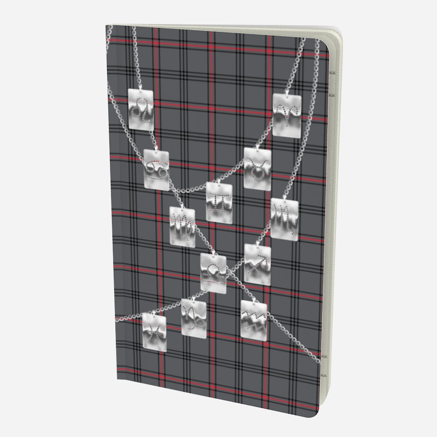 front cover of small notebook with silver zodiac tags on chains on a grey red and black plaid background