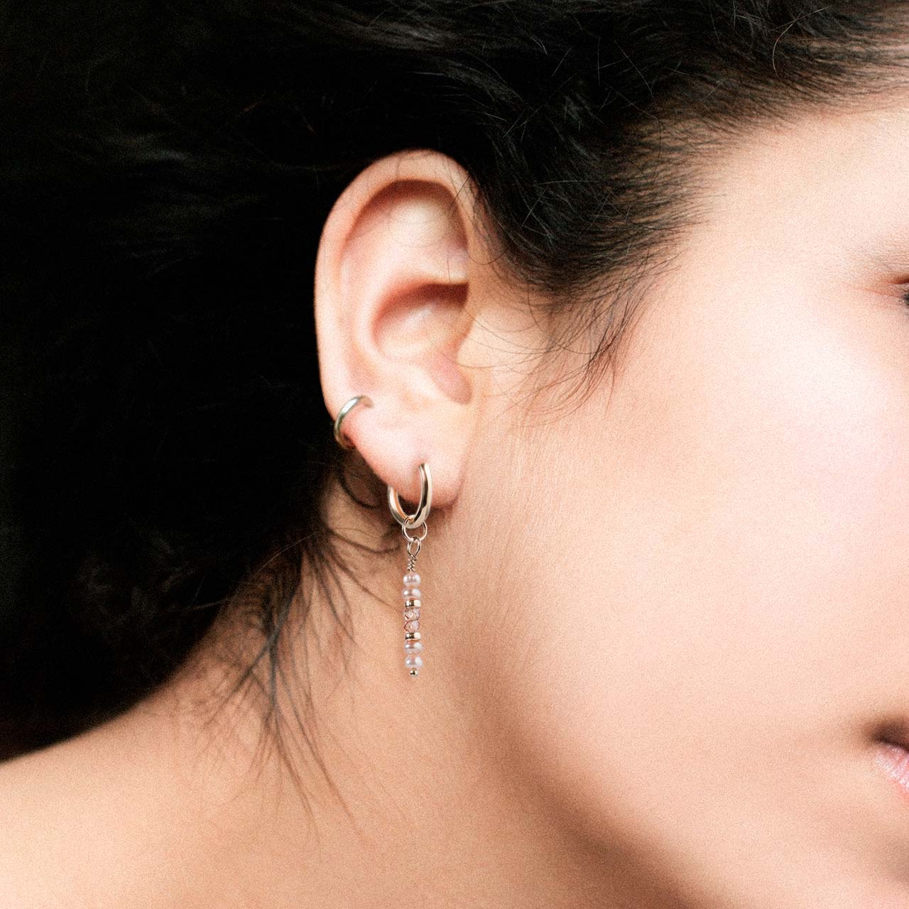 peach button pearl and peach zircon drop earrings on gold-filled huggie hoops on model ear