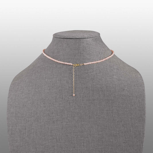 peach button pearl with gold filled lobster claw clasp and extender chain necklace back on grey textured necklace form