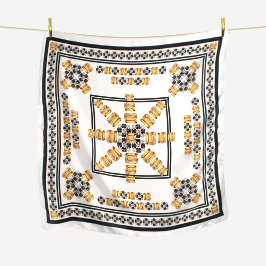 black white and citrine gem sunburst geometric design scarf hanging on wire with gold pins